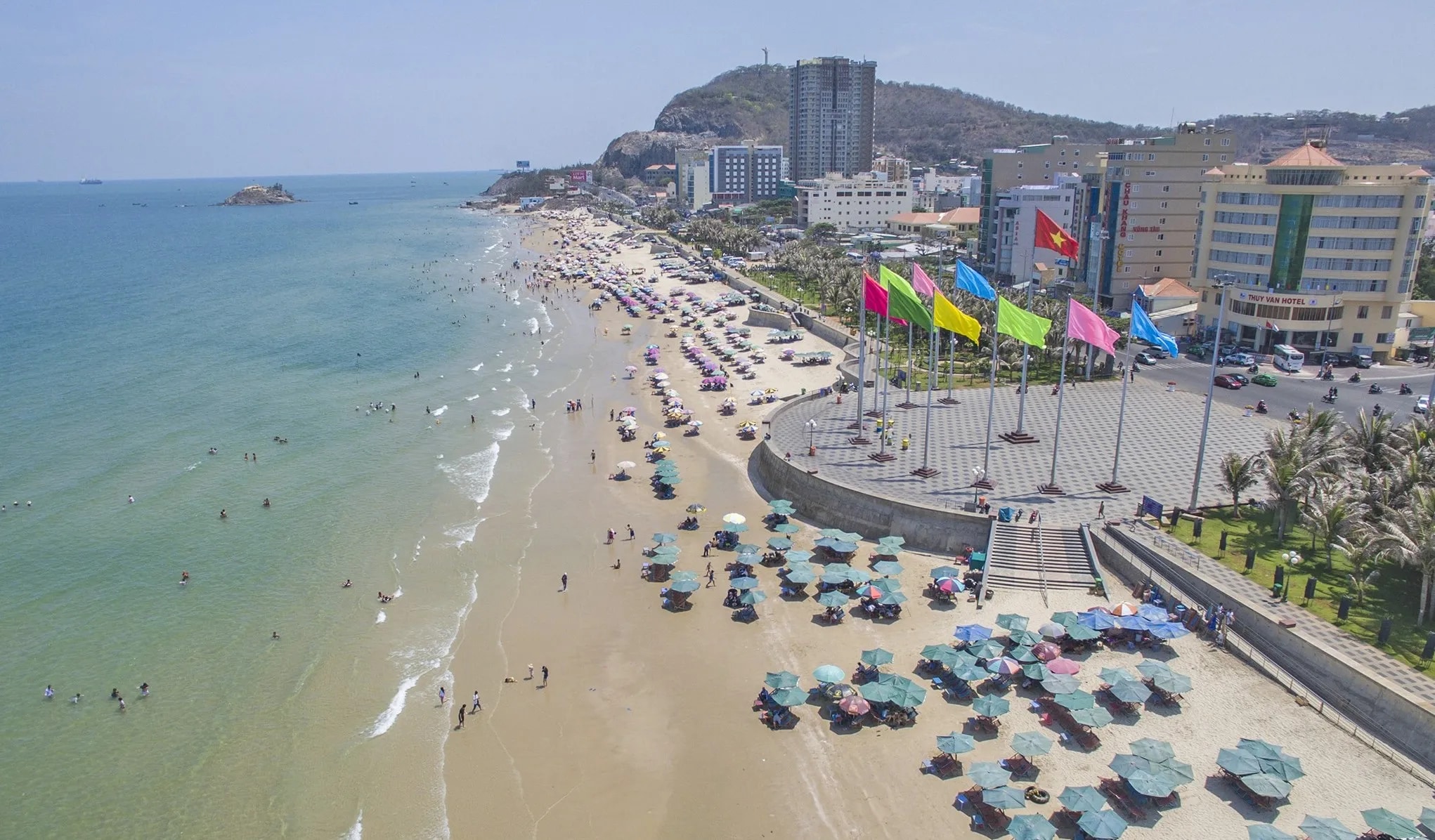 Back Beach's 8-kilometer golden sand coastline lined with modern resorts and traditional fishing boats creating perfect contrast 